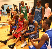 The rookies play video games at the photo shoot.
