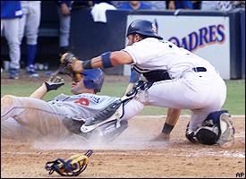 Los Angeles Dodgers' Paul Lo Duca, right, scores against Milwaukee