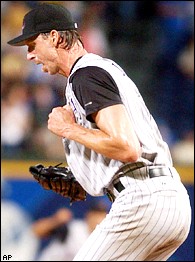 Arizona Diamondbacks pitcher Randy Johnson, right, hugs his