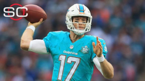 Miami Dolphins quarterback Ryan Tannehill (17) stands on a stage as the Miami  Dolphins unveil their new uniforms during an NFL football draft party,  Thursday, April 25, 2013 in Miami. Also shown