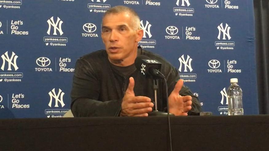 Joe Girardi is joined by wife Kim for a news conference at Yankee