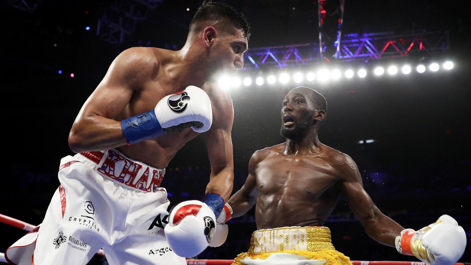 Crawford drops Khan in first round