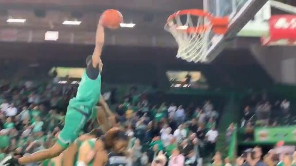 Marshall University student leaps over five guys to dunk
