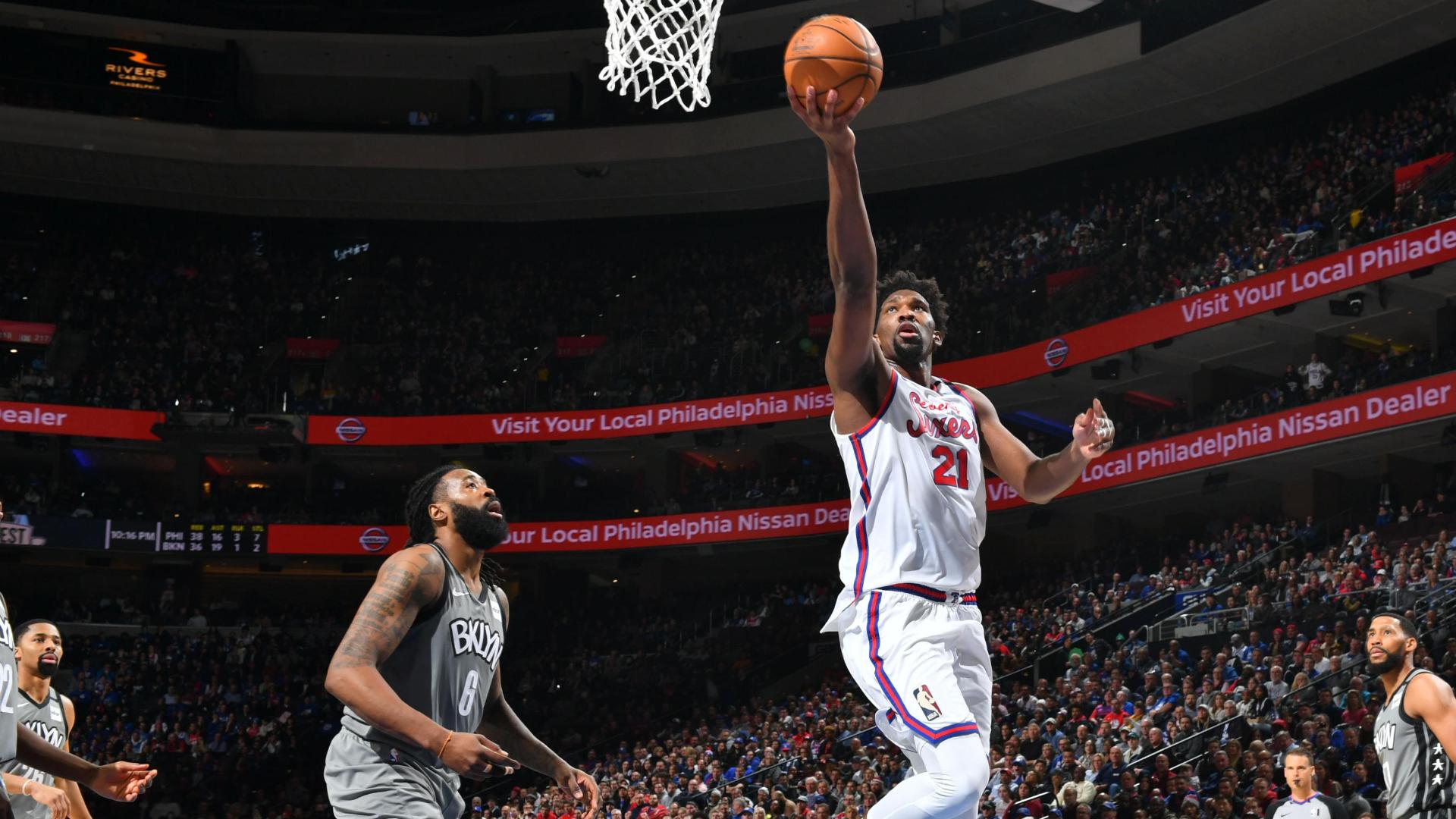 Embiid blows by Jordan with Eurostep