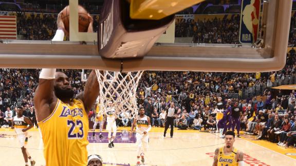 LeBron adds flare to double-clutch slam