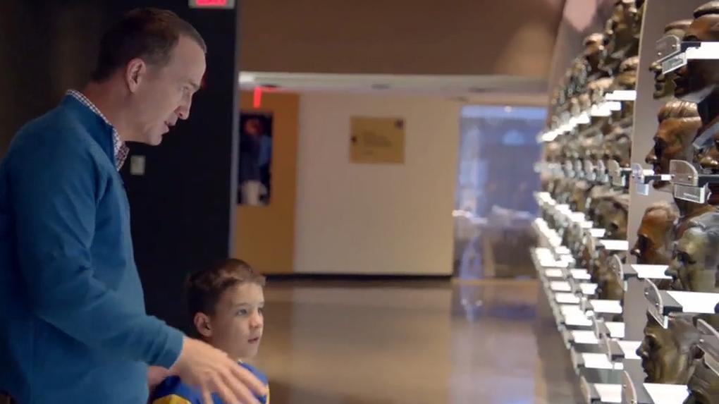 Peyton takes his son to the bust gallery at the Pro Football Hall of Fame