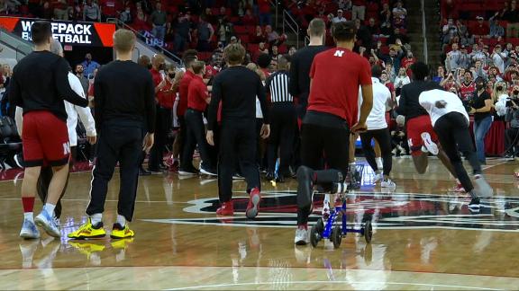Injured Nebraska player scooters over to check out scuffle with NC State