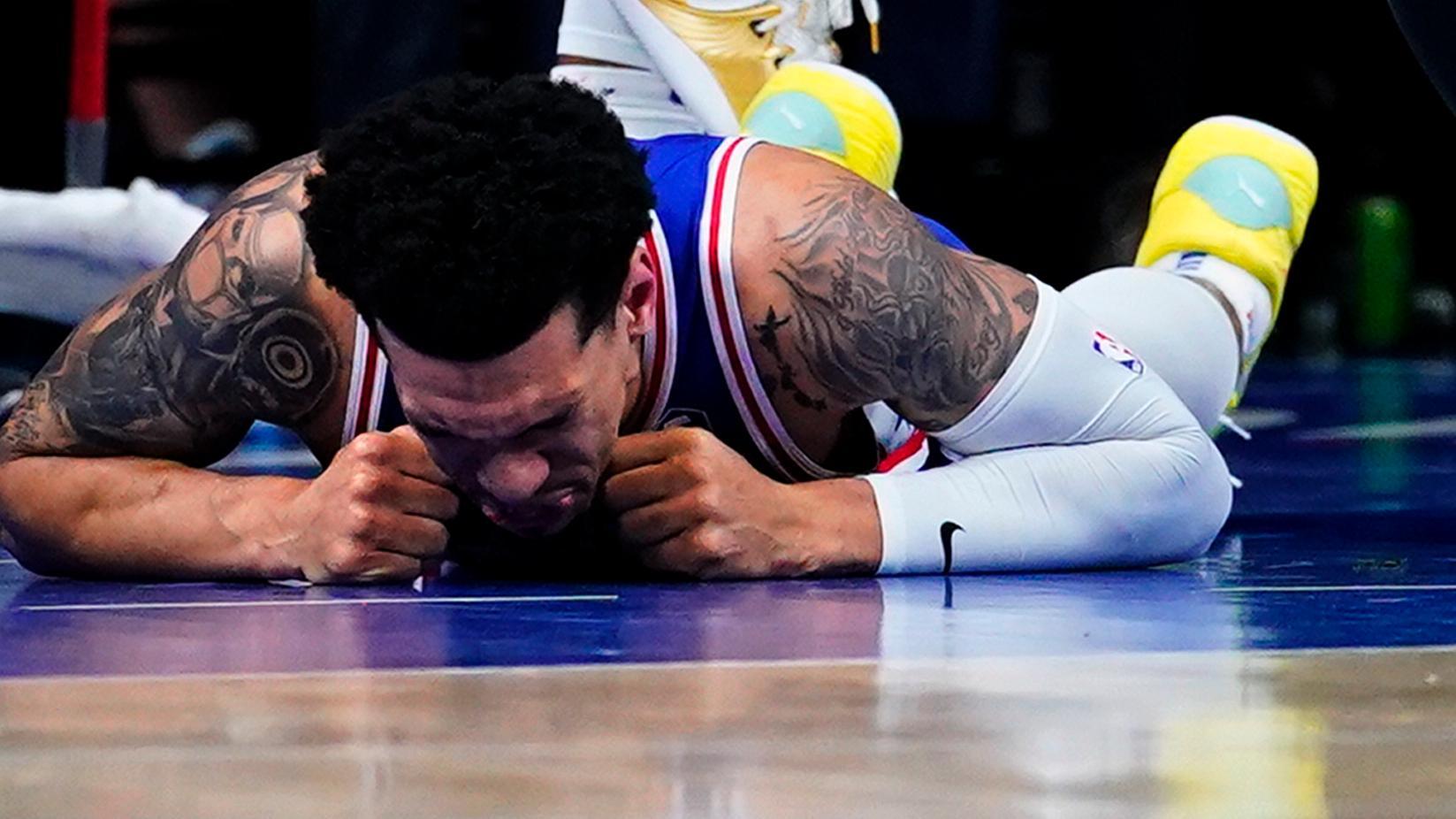 Danny Green suffers left knee injury after collision with Joel Embiid