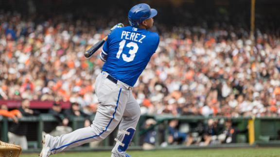 San Francisco Giants third baseman J.D. Davis, left, eludes a tag-attempt  by Kansas City Royals catcher Salvador Perez, right, as he scores on a  single by Thairo Estrada during the fourth inning