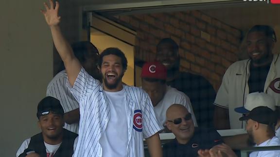 Caleb Williams waves to crowd at Cubs' game