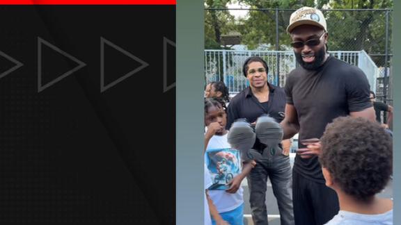 Jaylen Brown makes a young fan's day by giving him a pair of Brown's unreleased shoes while visiting Rucker Park in New York.