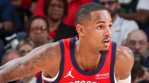 Dejounte Murray goes up for a 3-pointer and comes down holding his left wrist.