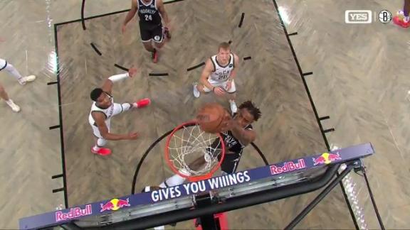 Nic Claxton snags the rock mid-air off the backboard and slams it home to pad the Nets' lead.