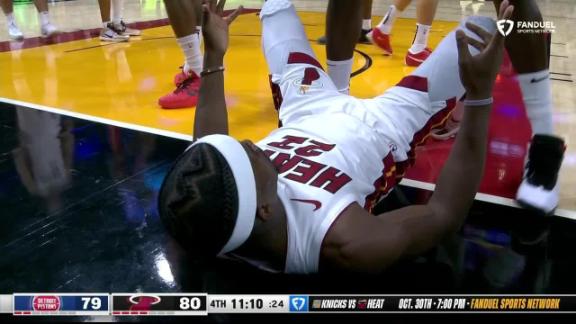 Jimmy Butler Eurosteps through the lane and somehow spins home his shot for the Heat.