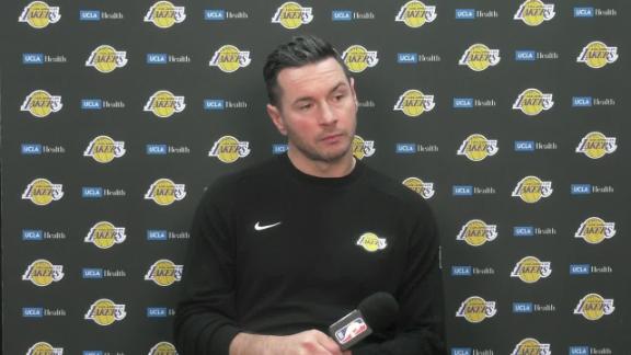 Lakers coach JJ Redick walks off during the team's postgame news conference.