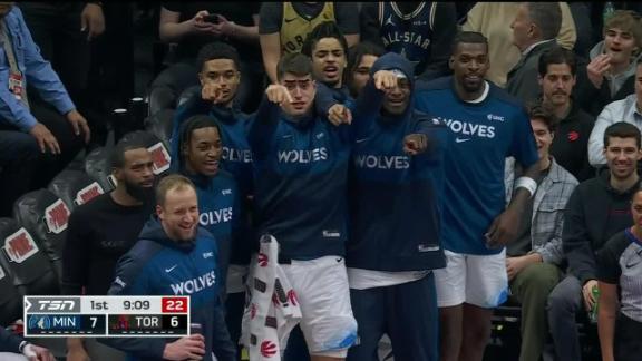 Jaden McDaniels throws down a left-handed slam all over Scottie Barnes to the delight of the Timberwolves bench.