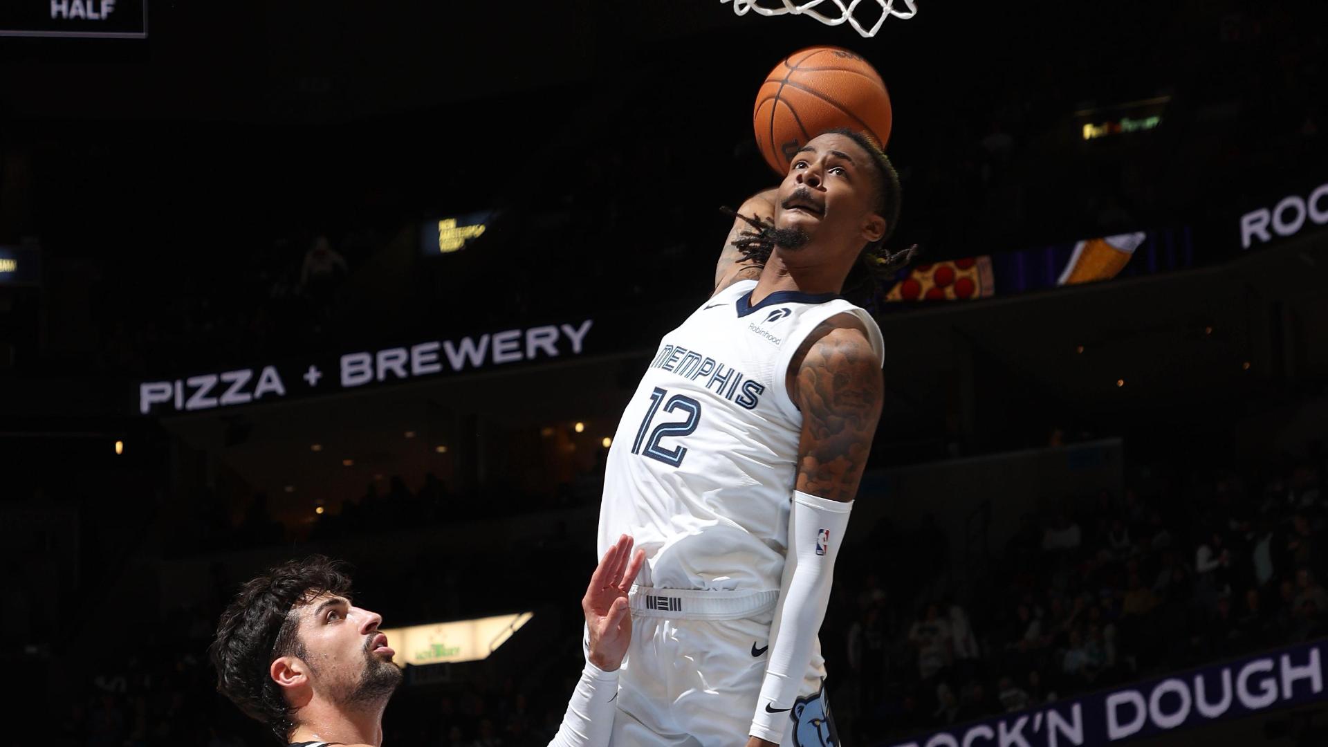 Ja Morant punishes the rim with a high-flying slam for the Grizzlies.