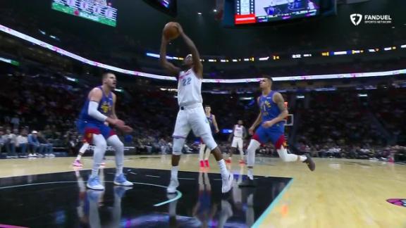 Jimmy Butler darts inside and throws down a dunk for the Heat in his first game back from suspension.