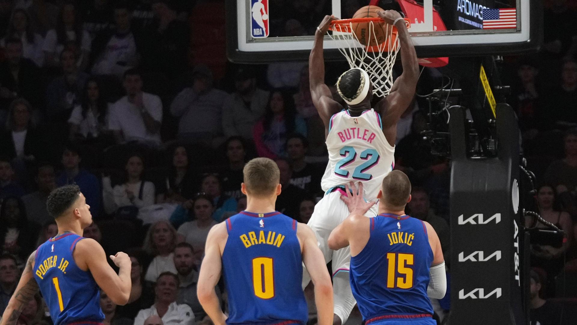 Jimmy Butler darts inside and throws down a dunk for the Heat in his first game back from suspension.