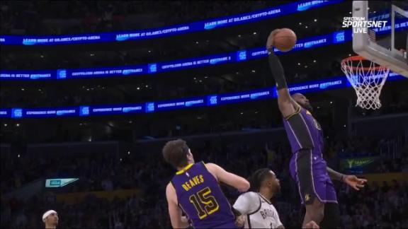 Austin Reaves throws a lob to LeBron James, who slams it home.