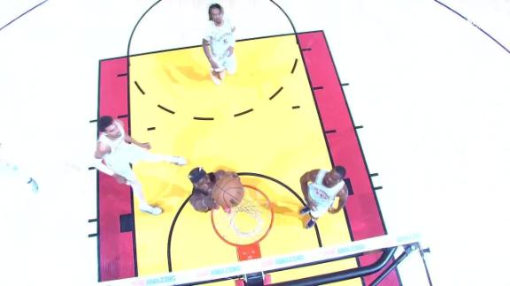 Jimmy Butler gets the ball and finishes with an early dunk for the Heat.