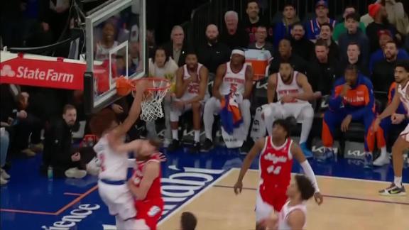 Miles McBride drives and doesn't let his defender get in the way of an emphatic dunk.