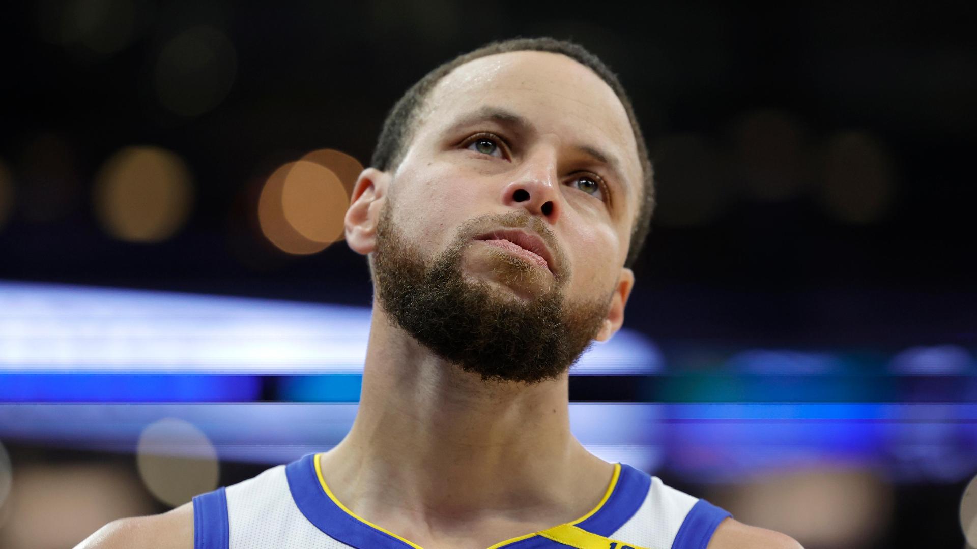 Steph Curry drains a high-arcing lefty layup from inside the 3-point line.