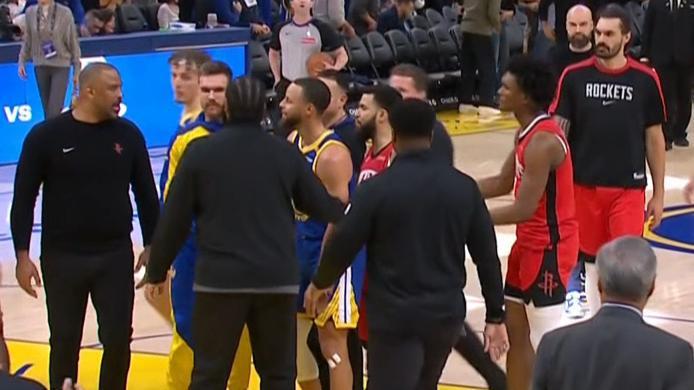 Rockets coach Ime Udoka appears to exchange words with Steph Curry before heading into the locker room for halftime.