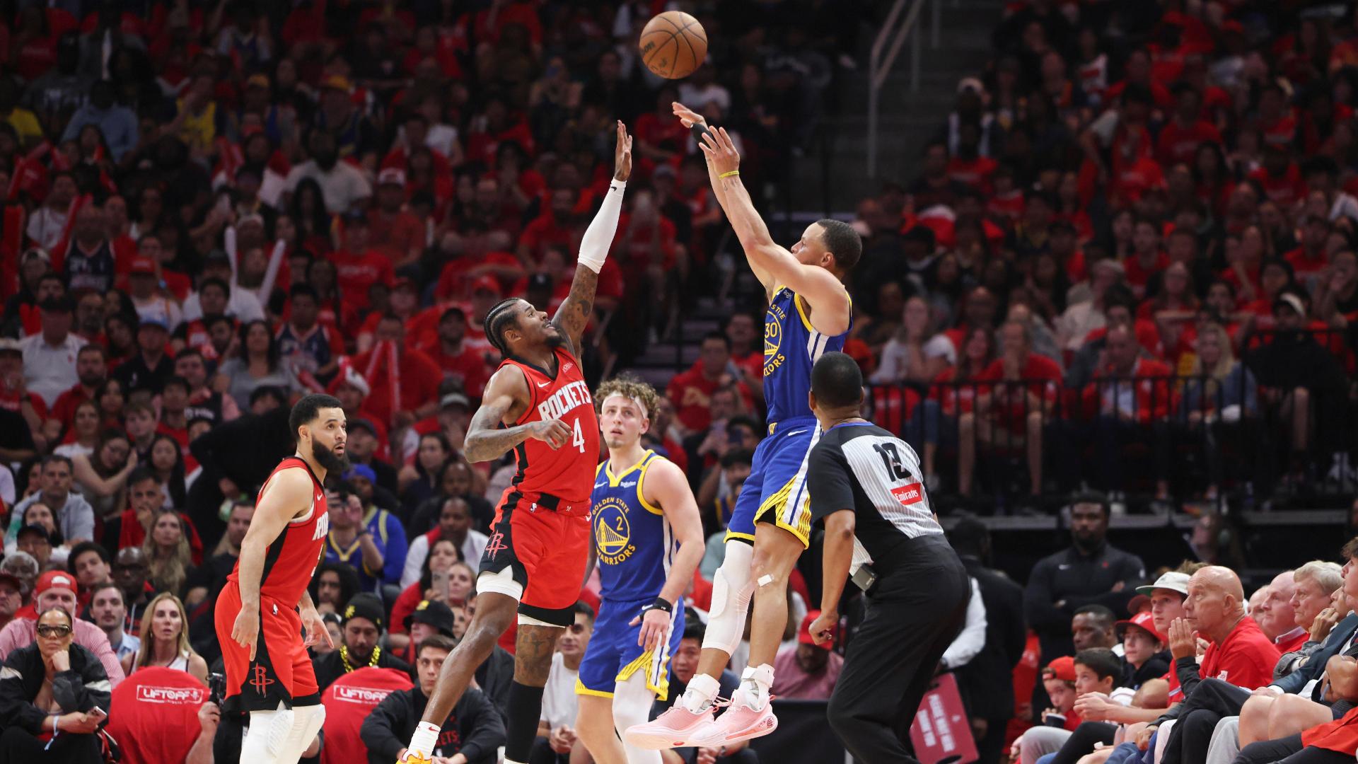 Steph Curry stuns the crowd with ridiculous contorting 3 to beat the shot clock.