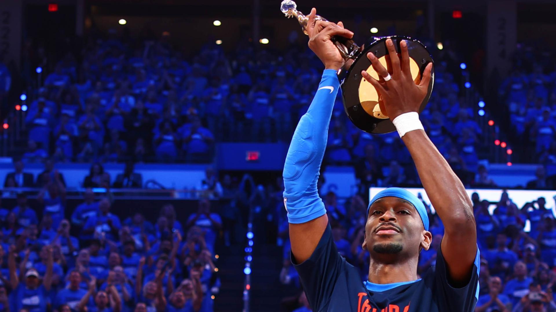 Shai Gilgeous-Alexander is awarded the Kia MVP award by NBA commissioner Adam Silver before Game 2 of the Western Conference finals.
