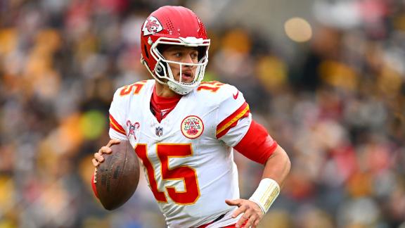 Patrick Mahomes wearing a Kansas City Chiefs jersey and helmet, about to throw a pass during a football game