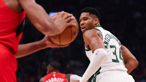 Giannis Antetokounmpo grabs an offensive rebound between two defenders and slams it in vs. the Raptors.