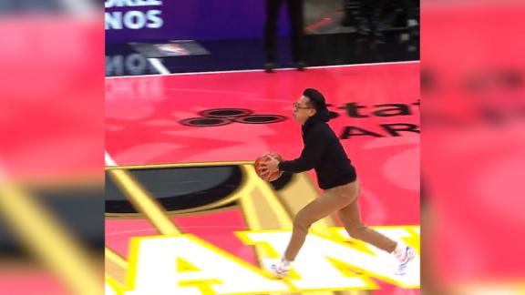 A Hawks fan swishes a half-court 3-pointer to win $10,000 during halftime.
