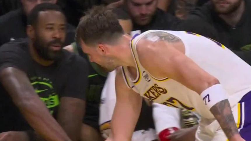 Luka Doncic and former teammate DeAndre Jordan share a brief greeting after the Lakers star sinks a corner 3-pointer.