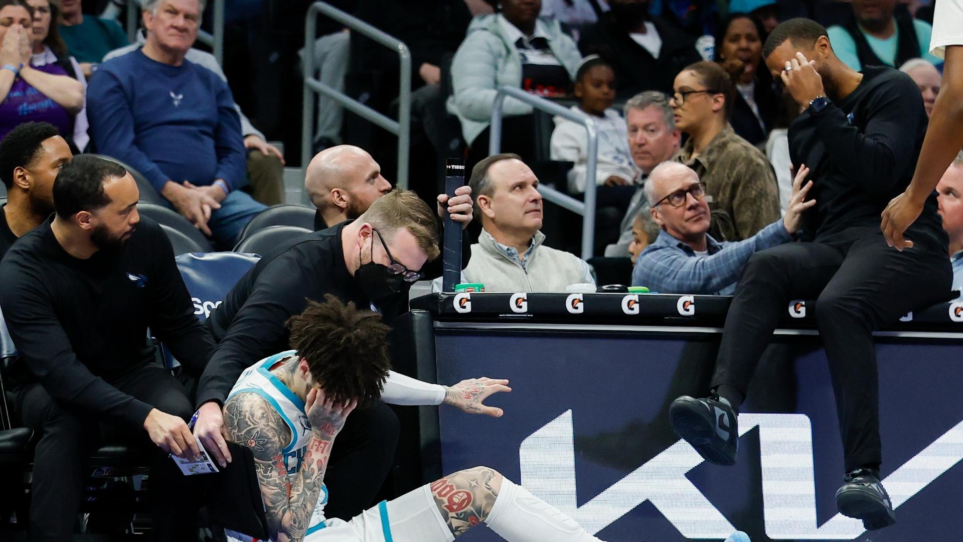 LaMelo Ball goes for a loose ball and bumps heads with his head coach Charles Lee.  