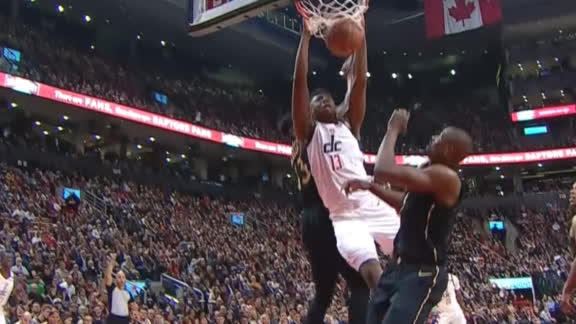 Bryant splits a pair of Raptors and slams