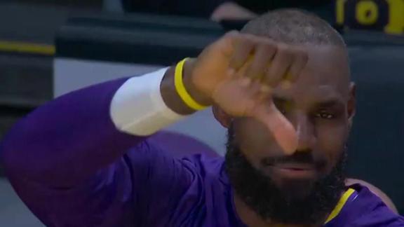 Dillon Brooks tries to score on Bronny James but ends up traveling, leading to LeBron giving him a thumbs-down on the bench.