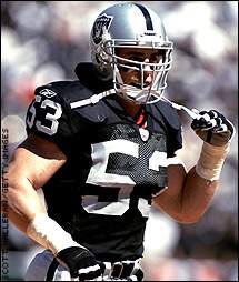 Oakland Raiders linebacker Bill Romanowski runs with the football