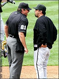 Chicago White Sox manager Ozzie Guillen (R) argues with home plate