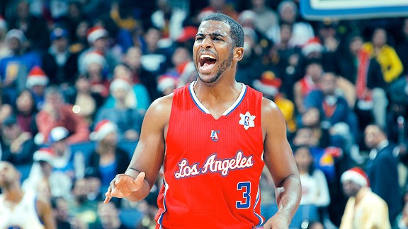 Blake Griffin hands on his waist in a Clippers red jersey