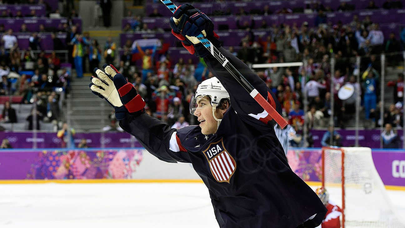 Team USA's T.J. Oshie celebrates with teammates after scoring a