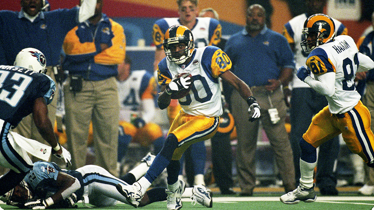 Former St. Louis Rams Isaac Bruce holds the Super Bowl trophy