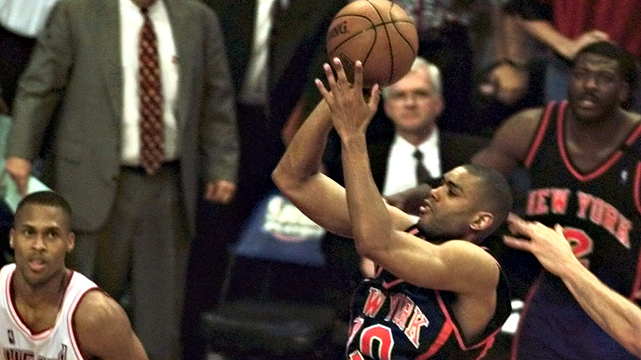 Latrell Sprewell of the New York Knicks hangs on the rim after