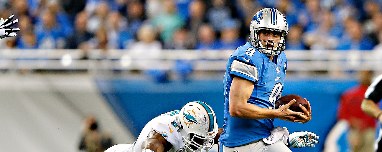 Referee Scott Novak (1) reviews a play during an NFL football game between  the Detroit Lions