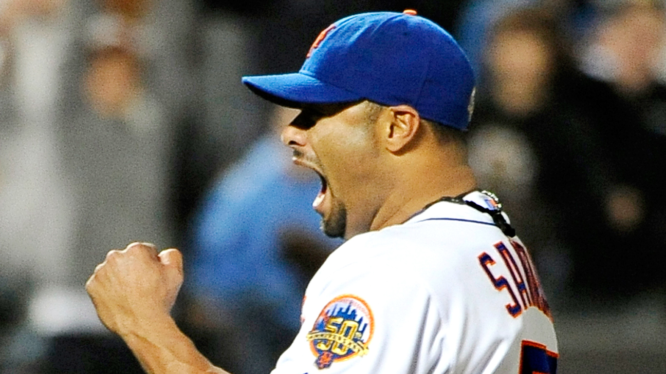 Pitcher Johan Santana wears his new cap and jersey during a news