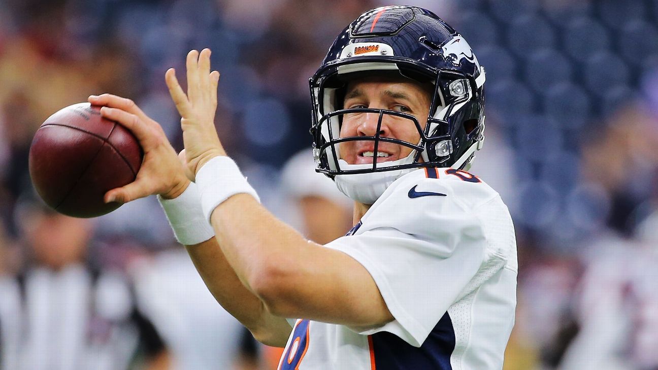 Denver Broncos quarterback Peyton Manning hands the ball off to