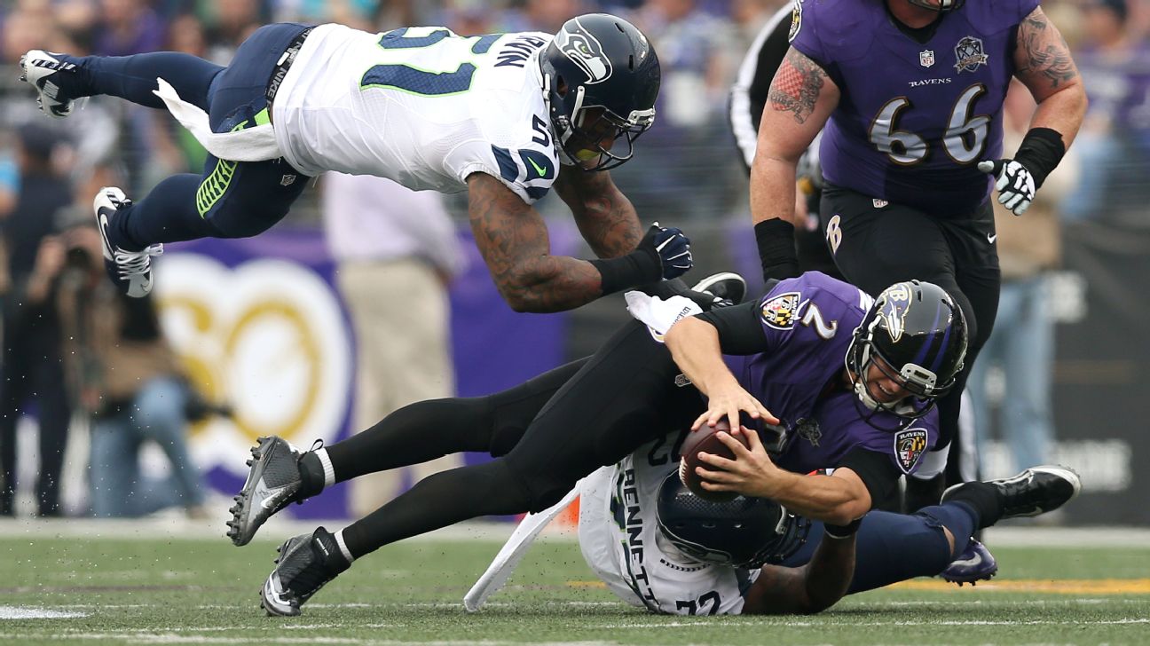 Baltimore Ravens' quarterback Jimmy Clausen passes under heavy pressure  during the fourth quarter against the Kansas City Chiefs' at M&M Bank  Stadium on December 20, 2015 in Baltimore, Maryland. Kansas City won