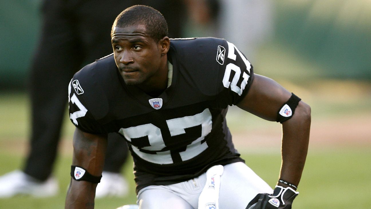 Oakland Raiders' Fabian Washington, (27), hangs his head as