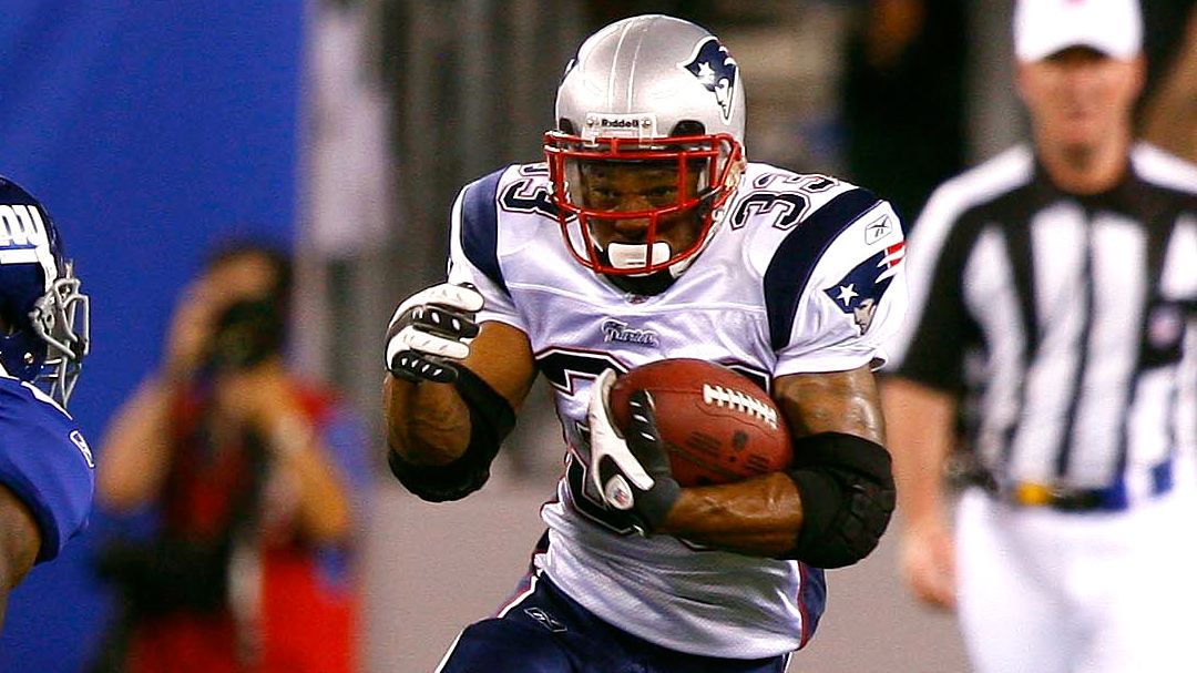 New England Patriot running back Kevin Faulk takes the ball from