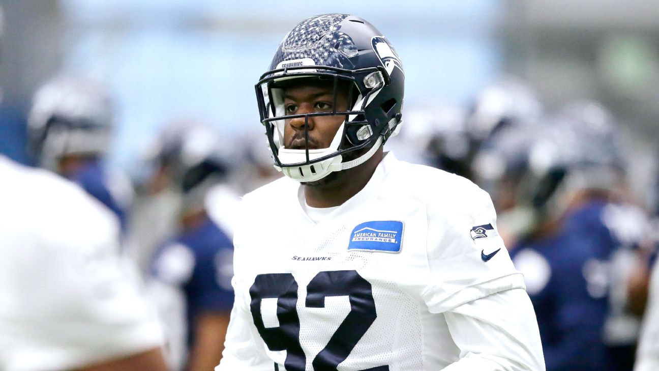 Seahawks' Quinton Jefferson tries to climb into stands to confront fans